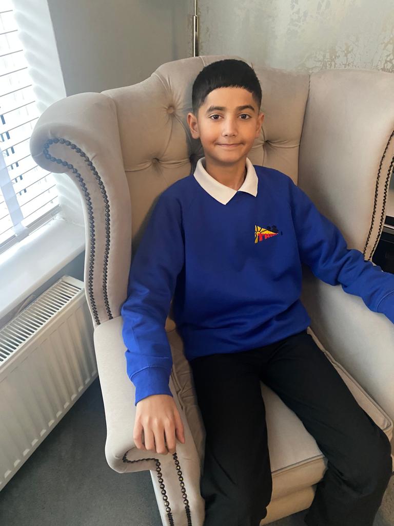 Musa with a cool smile sat on an armchair